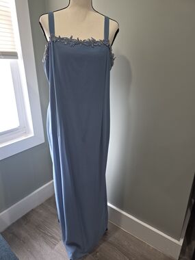 AFTER DARK .Sleeveless long evening gown featuring embroidered trim and
